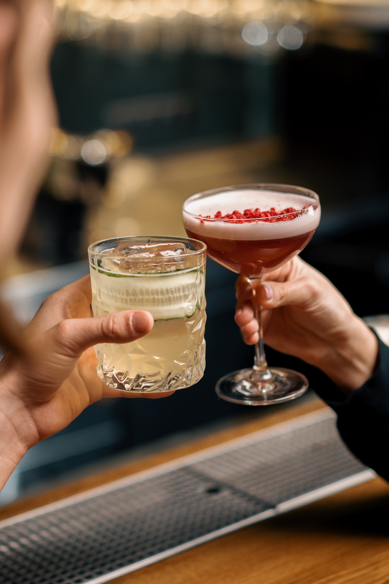 Close up of two people cheering cocktails in bar or disco club drinks and cocktails concept